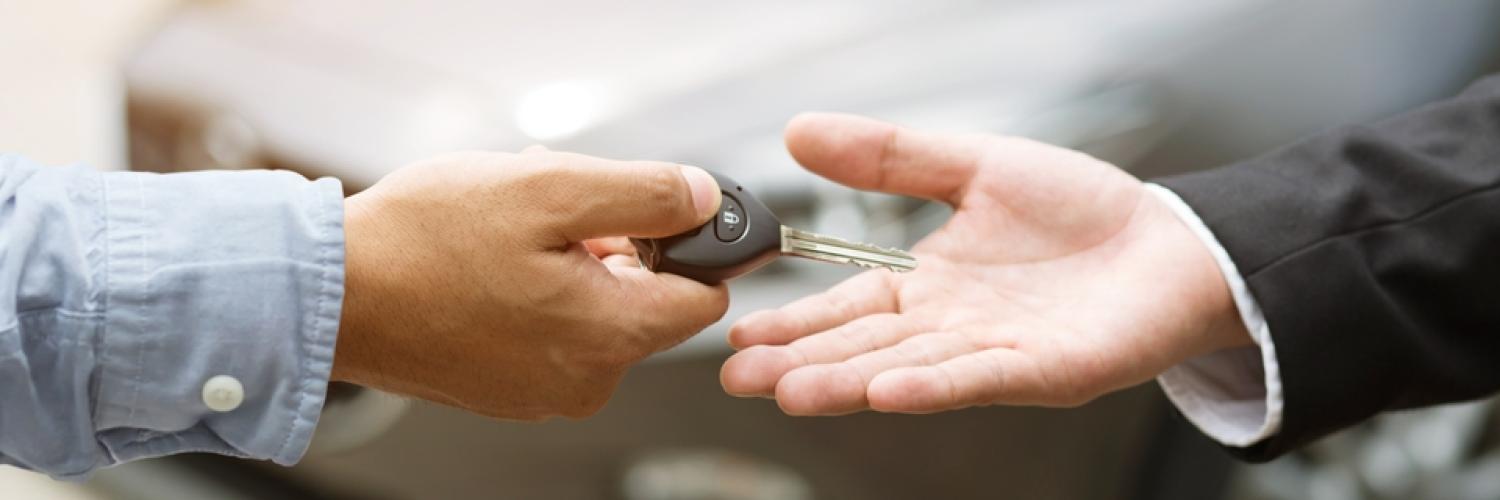 Schlüsselübergabe Auto im Hintergrund